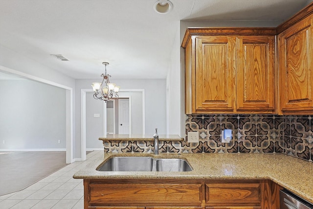 kitchen featuring sink, light stone countertops, light tile patterned flooring, decorative backsplash, and stainless steel dishwasher