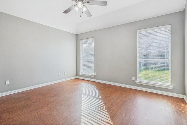 spare room featuring lofted ceiling, hardwood / wood-style floors, and ceiling fan