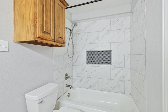 bathroom with tiled shower / bath combo and toilet