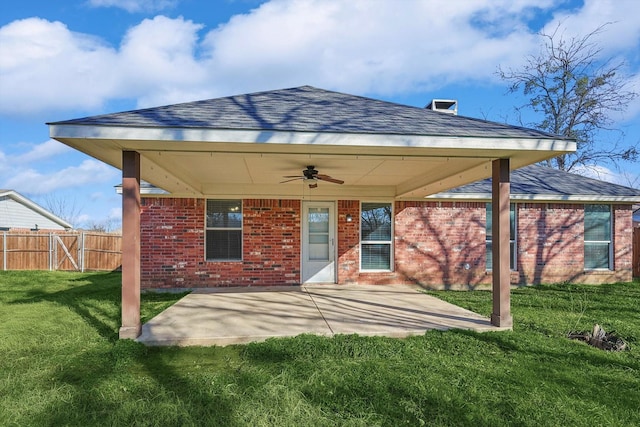 rear view of property featuring a yard, a patio, and ceiling fan