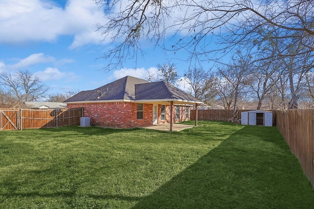 back of house with a yard, central AC, a shed, and a patio area