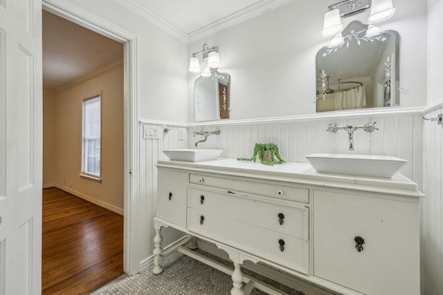 bathroom with crown molding, vanity, and wood-type flooring