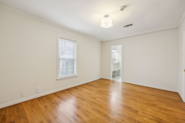 unfurnished room featuring ornamental molding and hardwood / wood-style floors