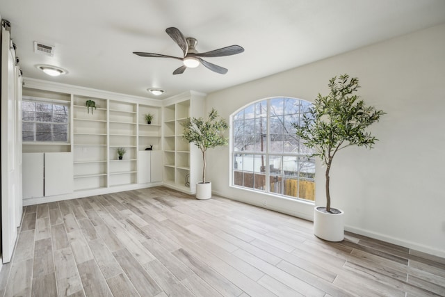 unfurnished room featuring ceiling fan and light wood-type flooring