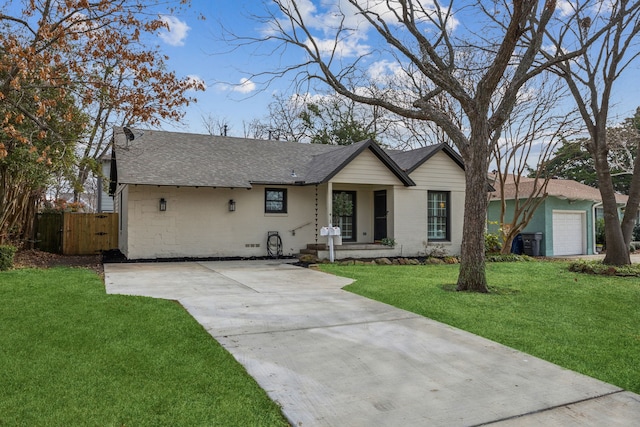 single story home featuring a garage and a front yard