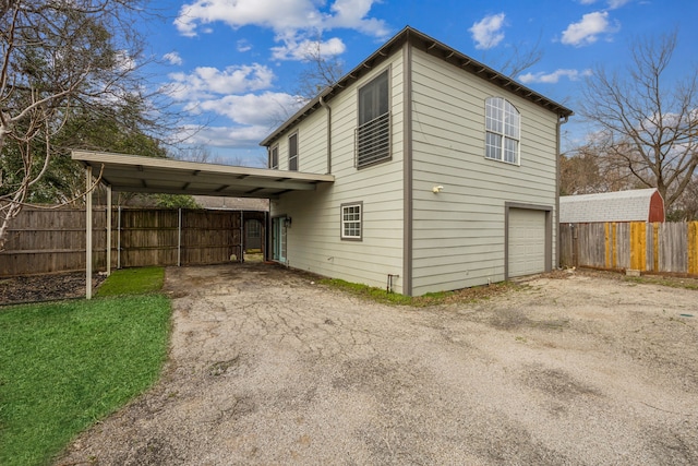 view of side of property with a garage and a carport