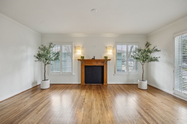 unfurnished living room with hardwood / wood-style flooring and ornamental molding