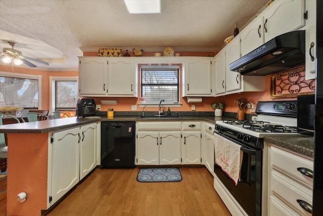 kitchen featuring sink, black dishwasher, extractor fan, gas range, and kitchen peninsula