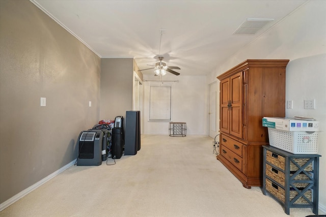 misc room featuring crown molding, ceiling fan, and light carpet