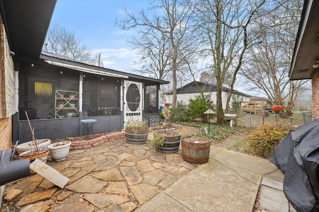 view of patio / terrace featuring a sunroom and grilling area