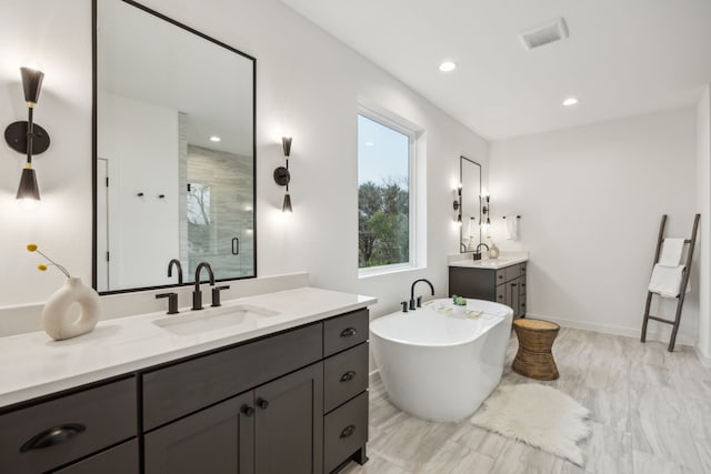 bathroom with vanity and plus walk in shower