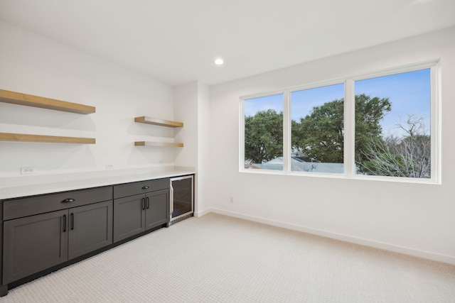 kitchen featuring light colored carpet and wine cooler