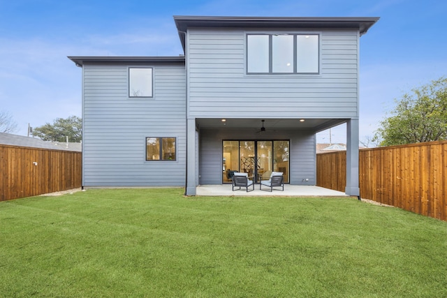 back of house with a patio area, ceiling fan, and a lawn