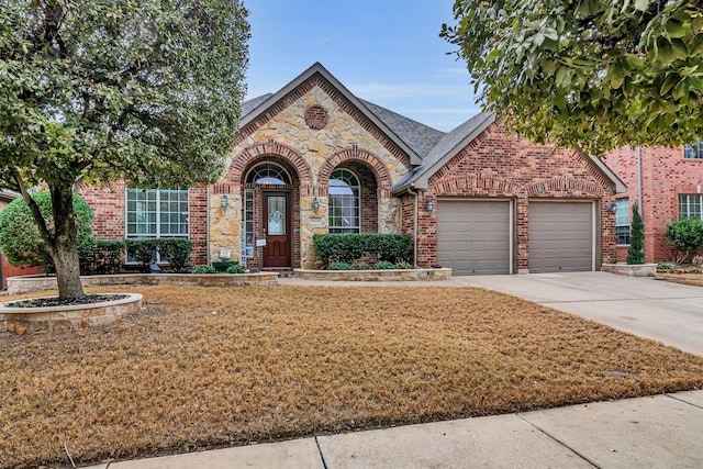 view of front of home with a garage and a front yard