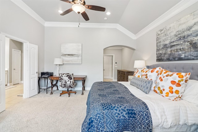 carpeted bedroom featuring ceiling fan, lofted ceiling, and ornamental molding