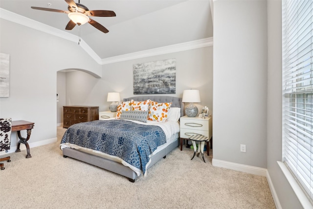 carpeted bedroom with multiple windows, ornamental molding, and vaulted ceiling