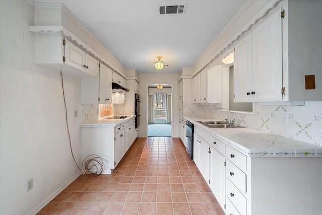 kitchen featuring white cabinetry, sink, light tile patterned flooring, and black appliances