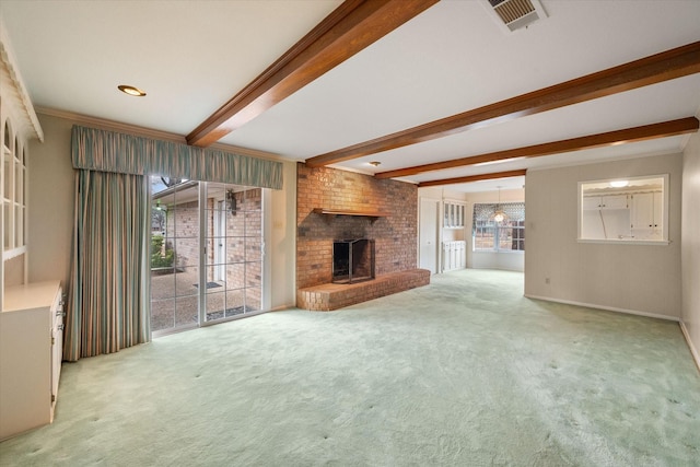 unfurnished living room with crown molding, a fireplace, beam ceiling, and carpet