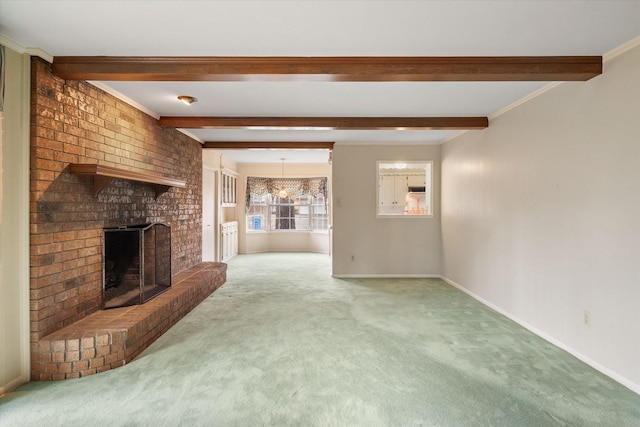 unfurnished living room featuring beamed ceiling, ornamental molding, carpet, and a fireplace