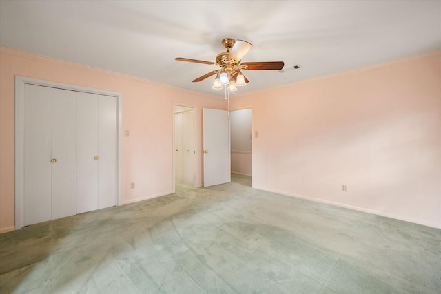 unfurnished bedroom with crown molding and light carpet