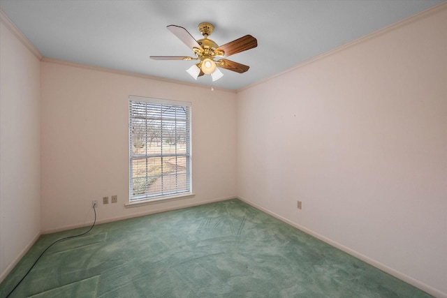 carpeted spare room featuring crown molding and ceiling fan