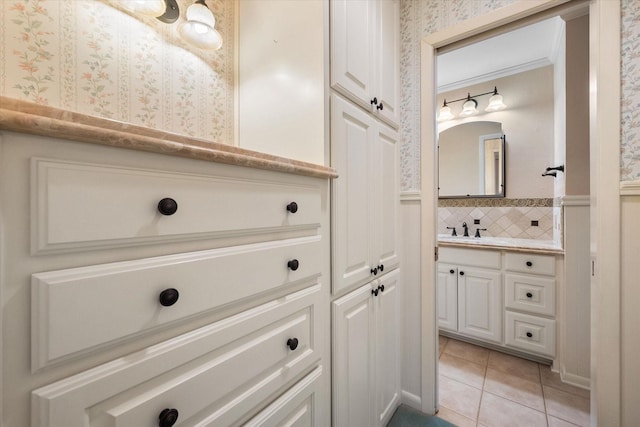 bathroom with tile patterned floors, vanity, and ornamental molding