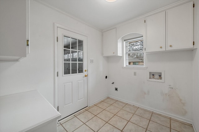 washroom with light tile patterned floors, crown molding, electric dryer hookup, cabinets, and washer hookup