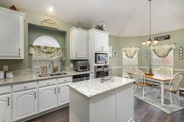 kitchen with sink, white cabinetry, decorative light fixtures, a center island, and appliances with stainless steel finishes