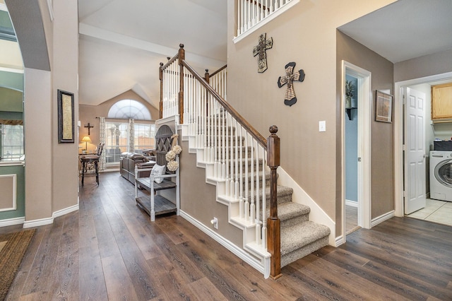 stairway with washer / dryer, wood-type flooring, and a high ceiling