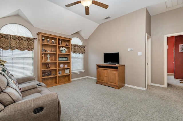 living room featuring ceiling fan, light colored carpet, and lofted ceiling