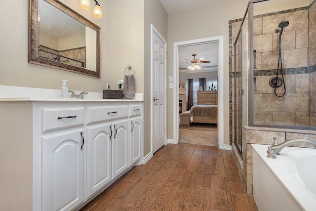 bathroom featuring vanity, hardwood / wood-style floors, independent shower and bath, and ceiling fan