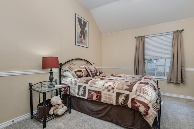 carpeted bedroom with lofted ceiling