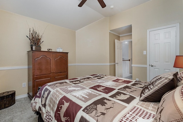 bedroom with lofted ceiling, light colored carpet, and ceiling fan