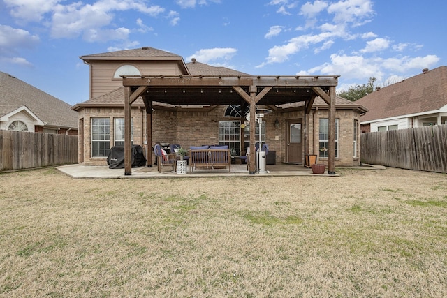 back of house with a hot tub, a yard, and a patio area