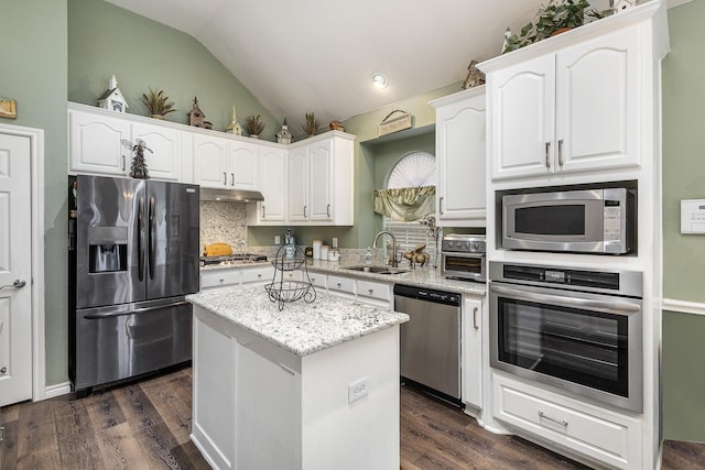 kitchen with sink, stainless steel appliances, a center island, and white cabinets