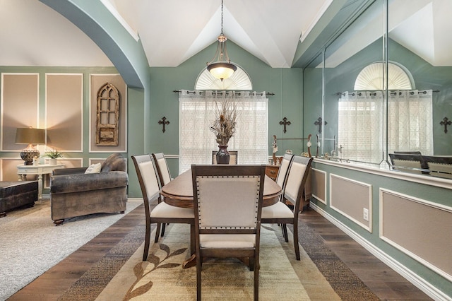 dining space with wood-type flooring and lofted ceiling