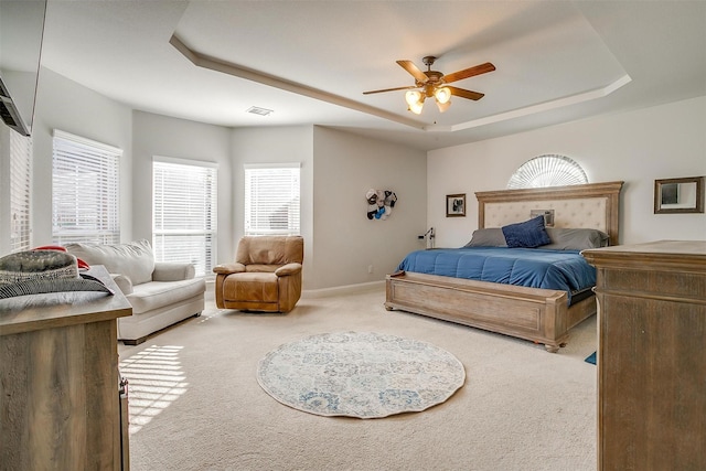 bedroom featuring carpet, ceiling fan, and a tray ceiling