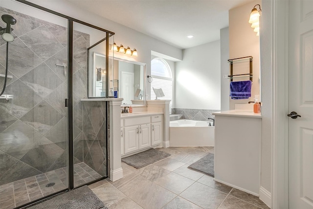 bathroom with independent shower and bath and vanity