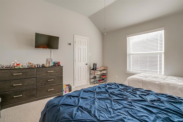 carpeted bedroom with lofted ceiling