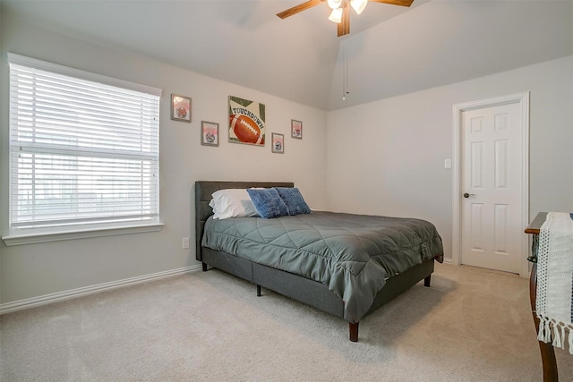 carpeted bedroom with ceiling fan and vaulted ceiling