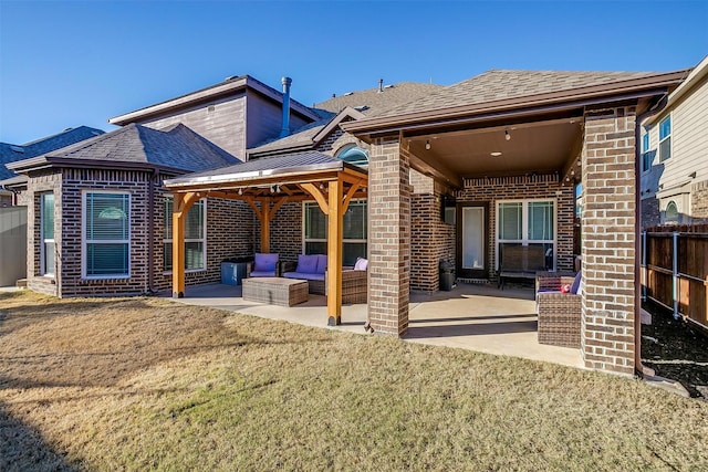 back of property with an outdoor hangout area, a lawn, and a patio area