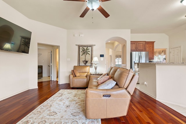 living room with dark hardwood / wood-style flooring and ceiling fan