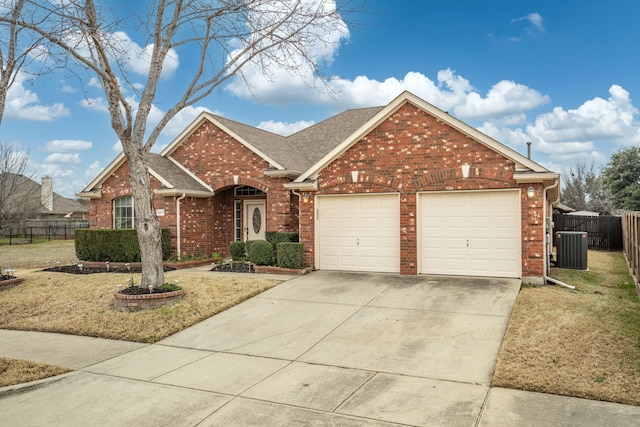 view of front property featuring central AC, a garage, and a front yard