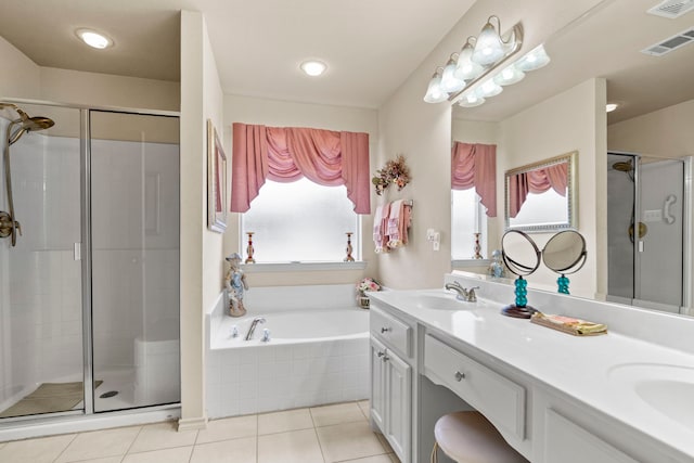 bathroom with a healthy amount of sunlight, independent shower and bath, and tile patterned flooring