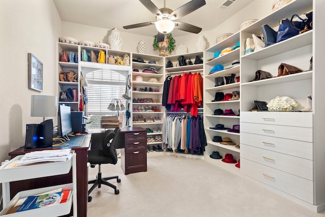 carpeted home office featuring ceiling fan