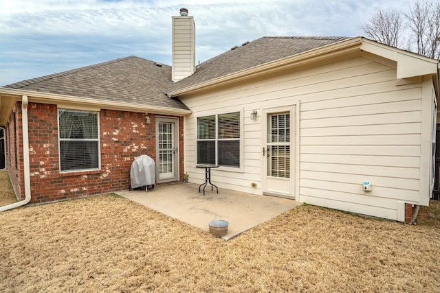 back of house featuring a yard and a patio area