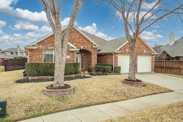 view of front of home with a garage and a front lawn