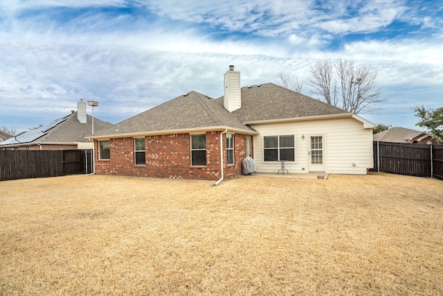 back of house with a yard