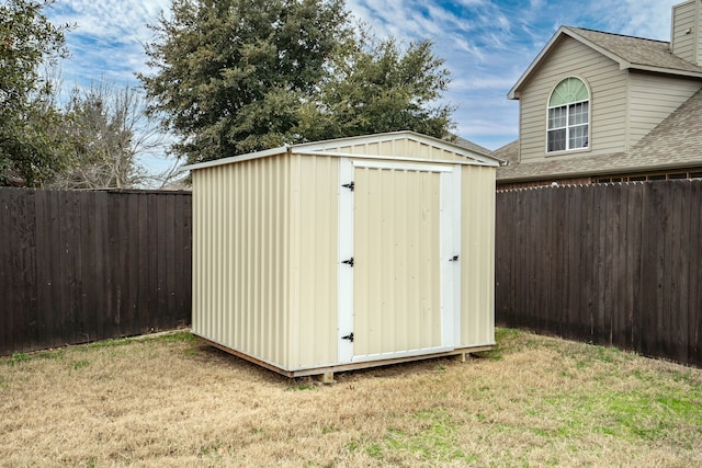 view of outbuilding featuring a lawn