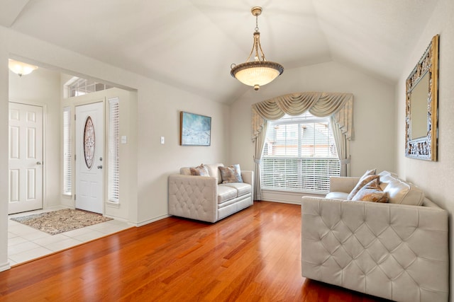 living room with lofted ceiling and hardwood / wood-style flooring